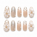Gilded Petal handmade press-on nails with clear flowers, gold centres, pearls and black dot accents