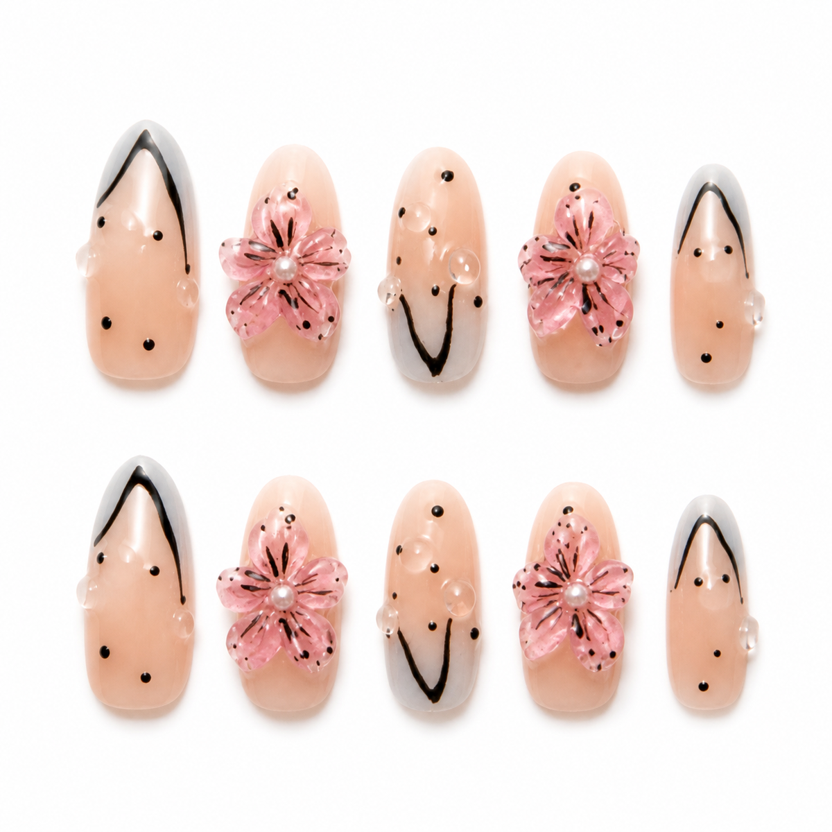 Ink Blossom handmade press-on nails with blush pink flowers, black linework and glossy dot details