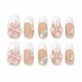 Porcelain Garden handmade press-on nails with white French tips, blush flowers, pearls and blue roses